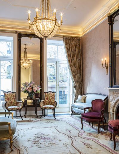 A living room with ornate furniture and a mirror.