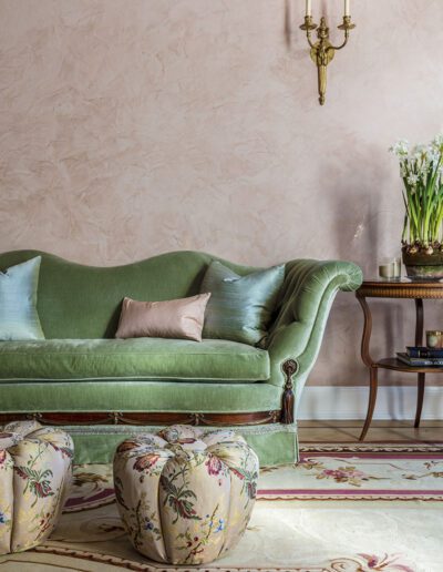 A green couch in a living room.