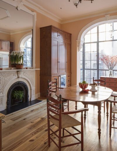 A dining room with a wooden table and chairs.