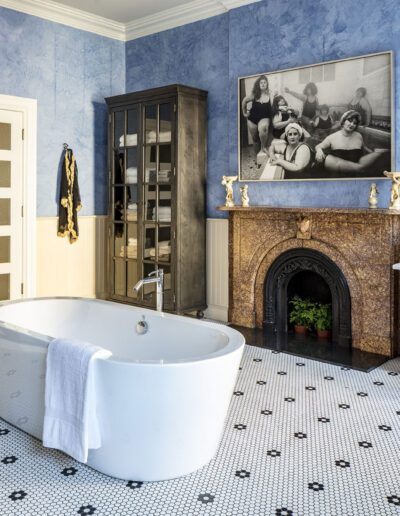 A bathroom with blue walls and a bathtub.