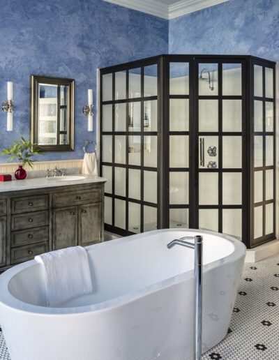 A bathroom with blue walls and a bathtub.