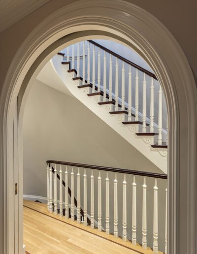 An archway leading to a staircase in a house.