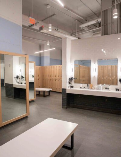 A locker room with wooden lockers and mirrors.