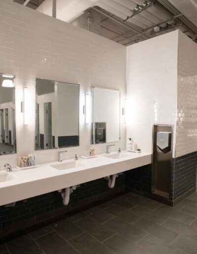 A bathroom with several sinks and mirrors.