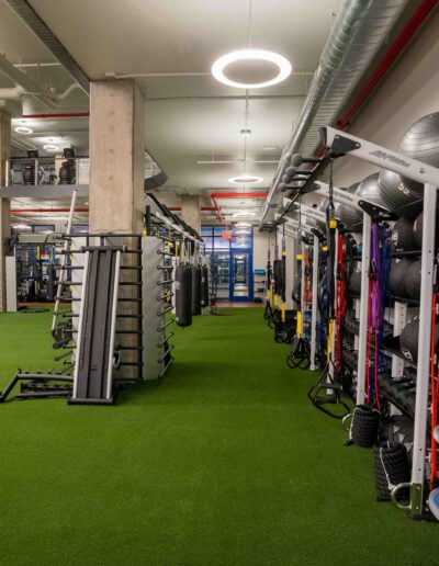 A gym with a lot of equipment on the floor.