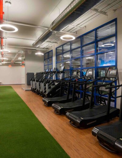 A gym with treadmills, ellipticals, and other exercise equipment.