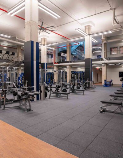 A gym with a lot of equipment in it.