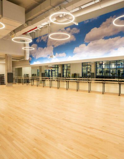 An empty dance studio with wooden floors and ceilings.