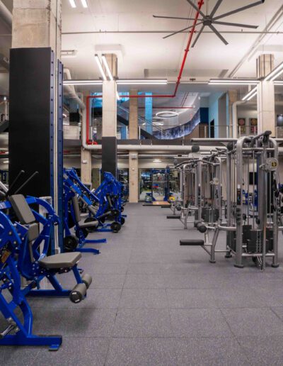 A gym with a lot of equipment in it.