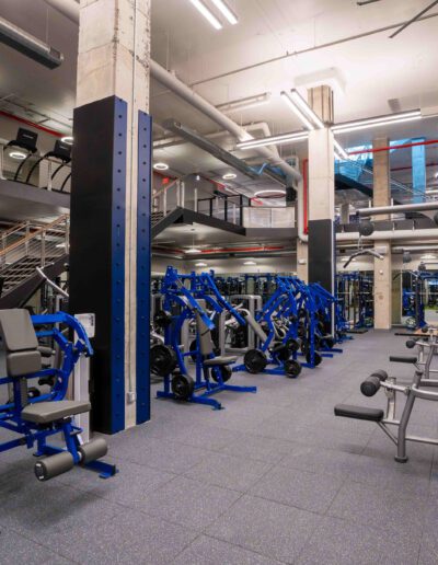 A gym with a lot of equipment in it.