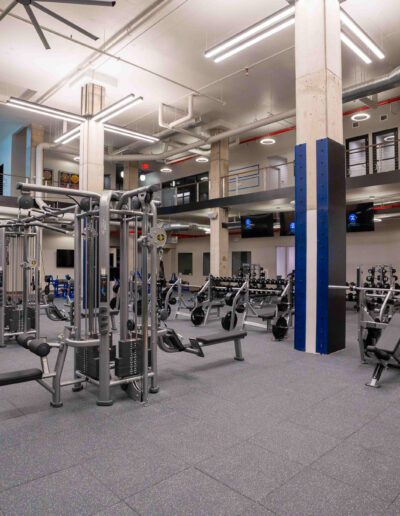 A gym with a lot of equipment in it.