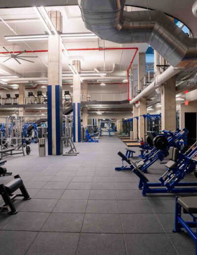 A gym with a lot of equipment in it.