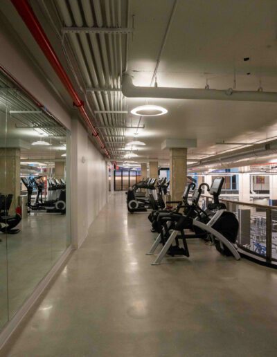 A gym with a lot of equipment and mirrors.