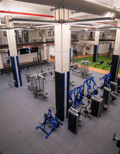 A gym with a lot of equipment in it.