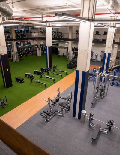 A gym with a lot of equipment in it.