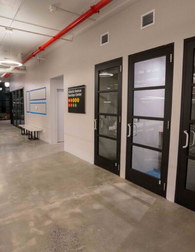 A hallway in an office with glass doors.