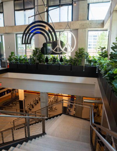 The lobby of a building with stairs and plants.