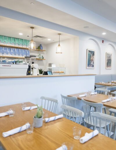 The interior of a restaurant with tables and chairs.