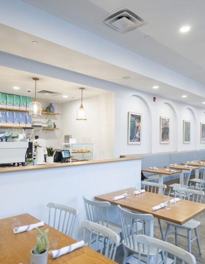 The interior of a restaurant with tables and chairs.