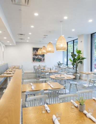 The interior of a restaurant with tables and chairs.