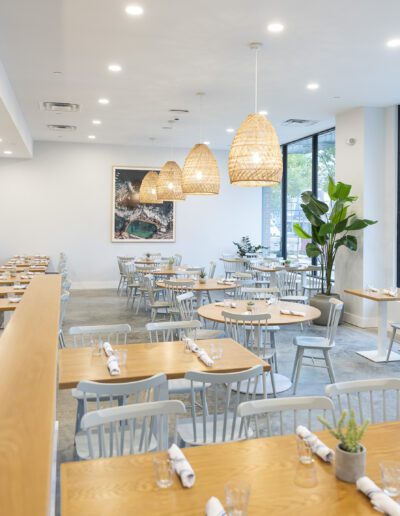 The interior of a restaurant with tables and chairs.