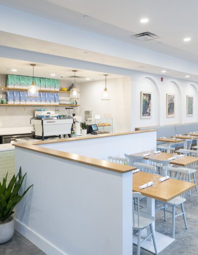 The interior of a restaurant with tables and chairs.