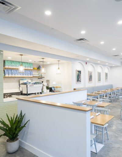 The interior of a restaurant with tables and chairs.