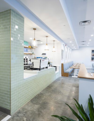 The interior of a restaurant with a green tiled wall.