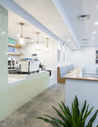 The interior of a restaurant with a green tiled wall.