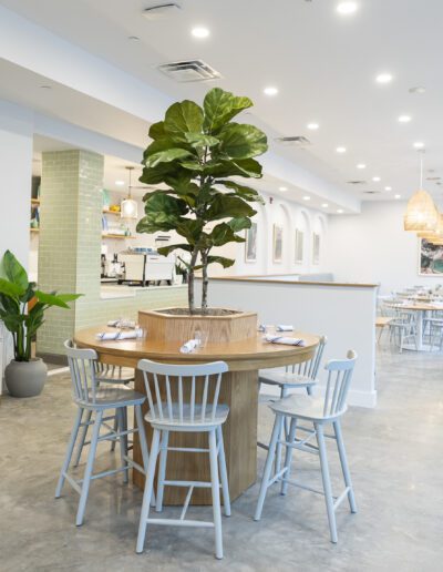 The interior of a restaurant with a table and chairs.