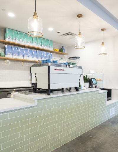 A coffee shop with a green tiled wall.