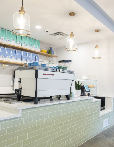 A coffee shop with a counter and tables.